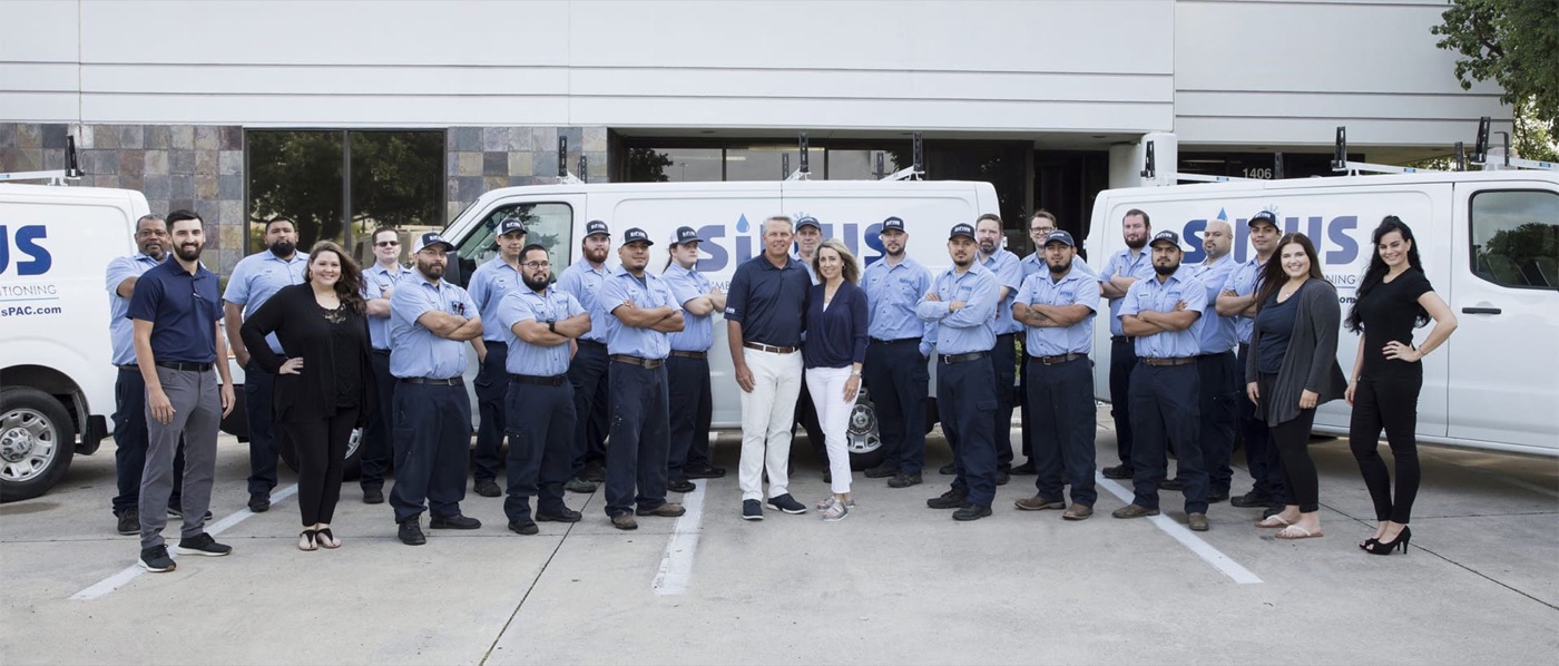 The Sirius Plumbing and Air Conditioning team outside its Carrollton workplace with branded service vans.